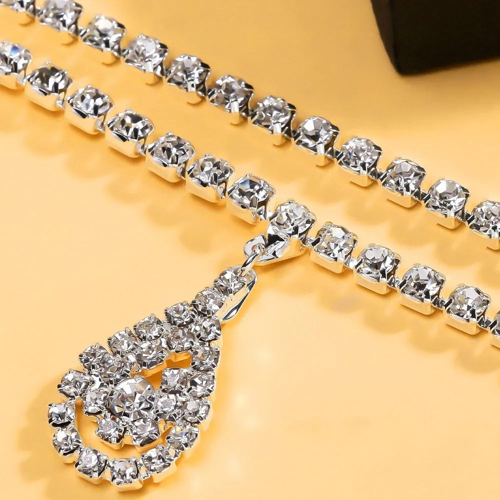 Gold and silver water drop pendant waist chain for women with rhinestones and tassel detailing.