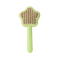 Green handle self-cleaning stainless steel needle comb for cats on a white background