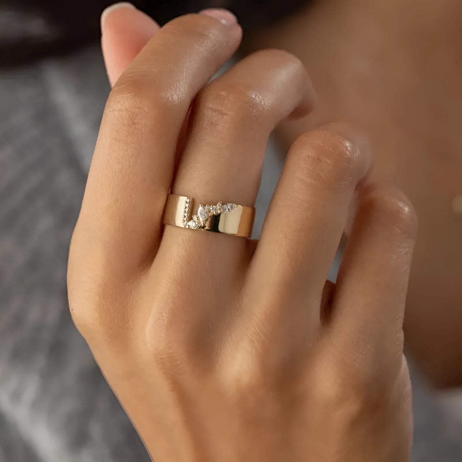 Gold electroplated copper ring with shining zircon details showing side profile view