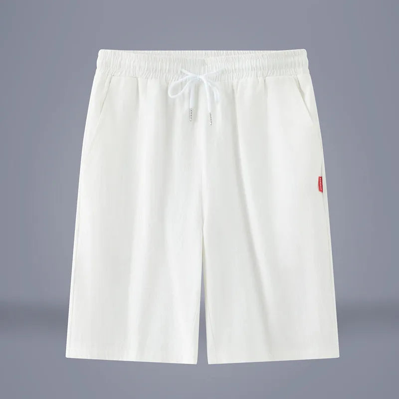 Solid colour cotton linen cropped summer pants with a drawstring waistband on a hanger.