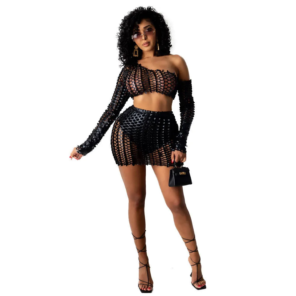 Women's black hollow-out net dress two-piece set with sleeveless top and short skirt.
