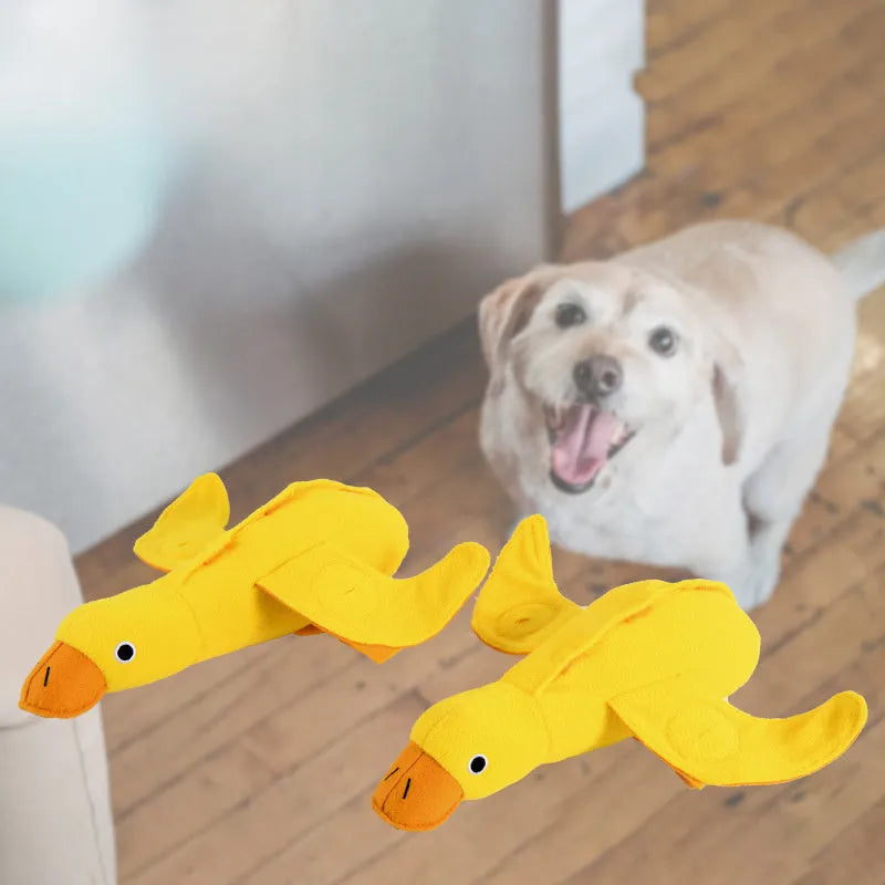 Yellow teddy dog toy with central duck doll, featuring a squeaker and treat leak compartment.