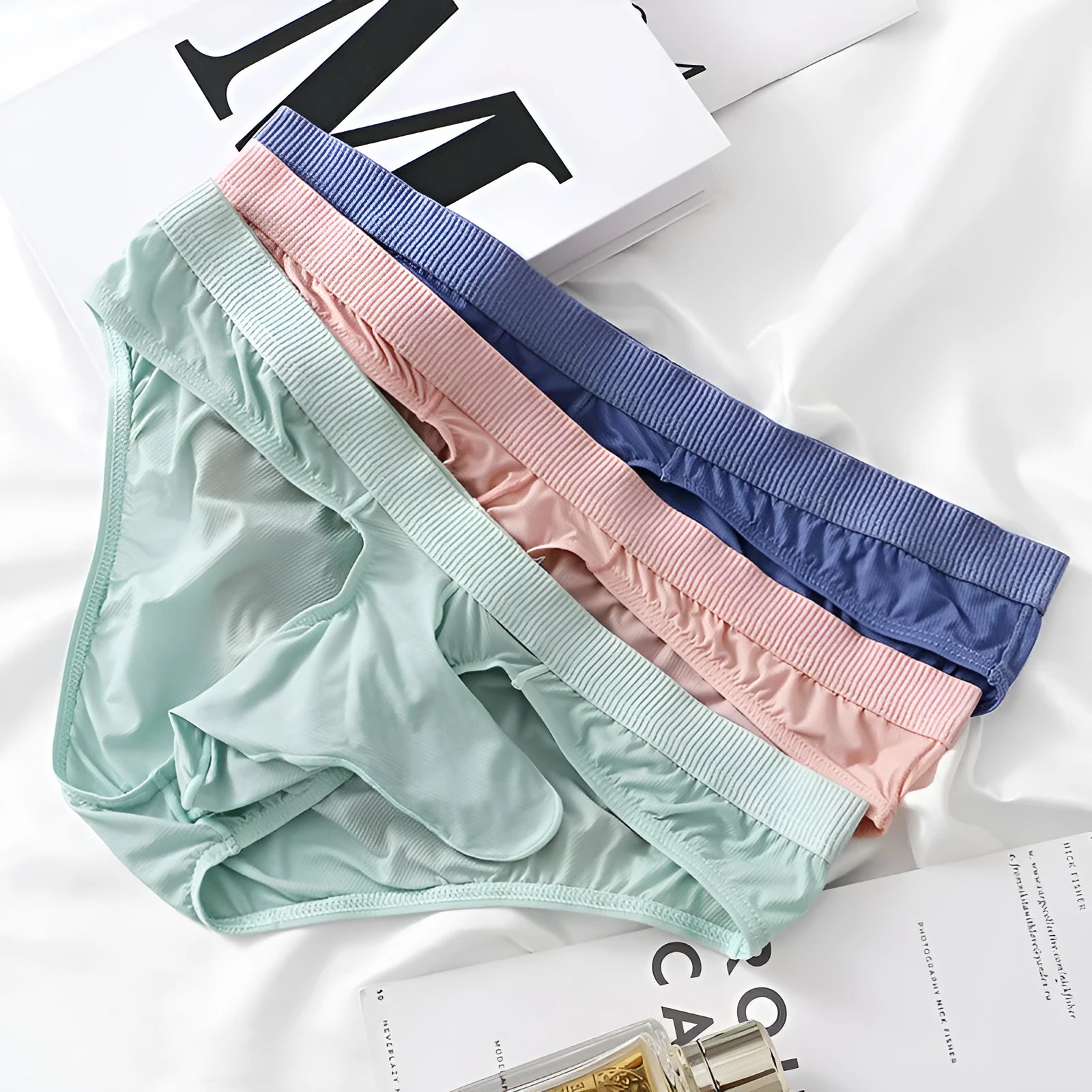 Men's low waist briefs in ice silk fabric on a white background, showing the brief style.
