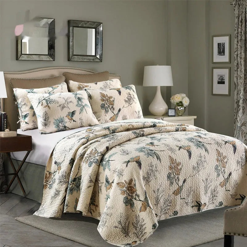 Quilted cotton bed cover set with printed pattern on bed with matching pillowcases