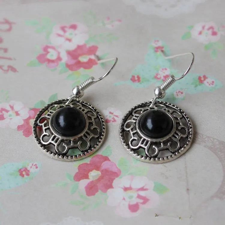 Handmade Miao silver earrings with turquoise flower disk design and ethnic totem patterns in red blue or black colour options