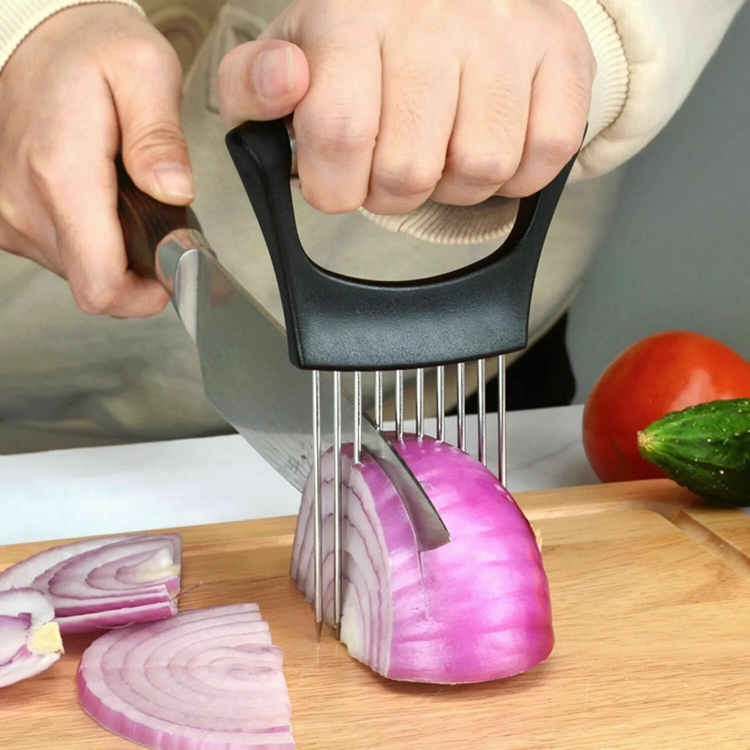 Stainless steel and ABS onion holder slicer for securing tomatoes and vegetables during cutting.