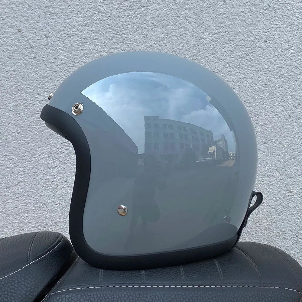Retro-style fibreglass motorcycle half helmet shown in cement grey colour option