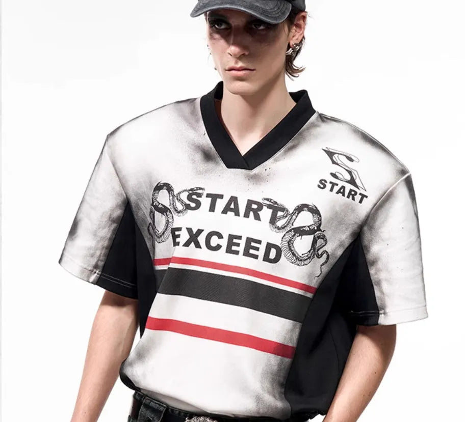 V-neck short sleeve top with padded shoulders featuring letter snake pattern print
