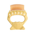 Shell-shaped plastic pet grooming brush with bent wire bristles and anti-slip handle