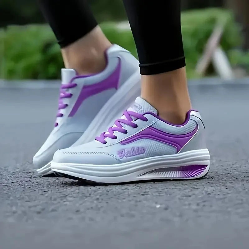 Women's grey and black middle heel travel and sports shoes showing side profile.