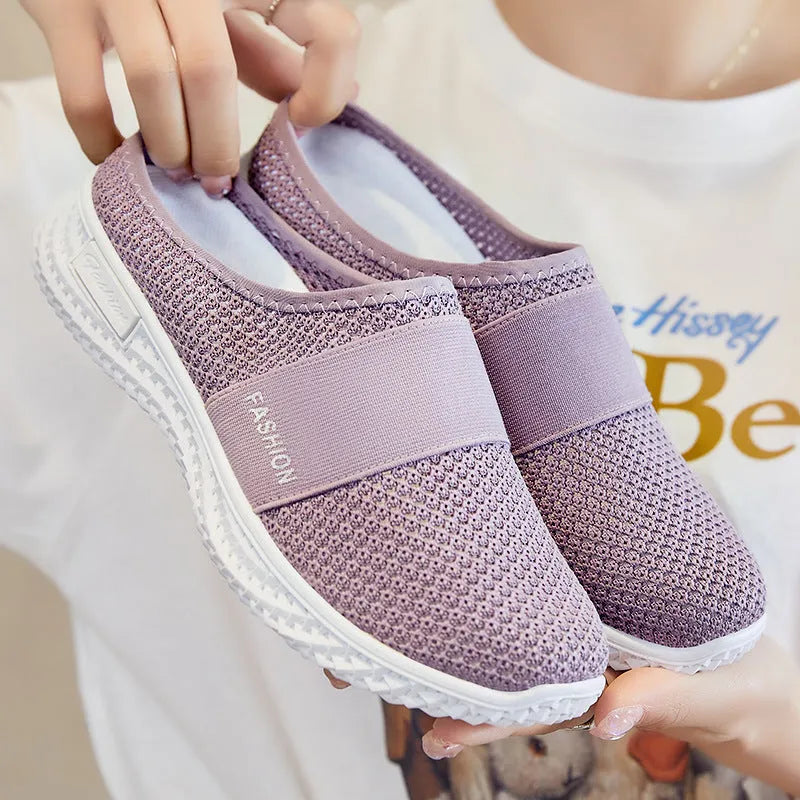 Women's casual flat shoe in breathable mesh, showing hollow-out detail and round toe, in a choice of colours.