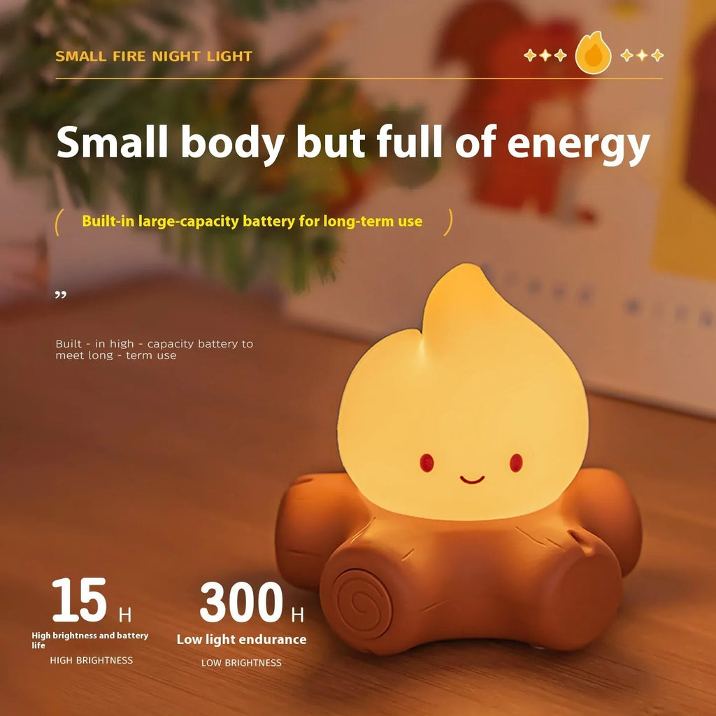 Silicone small fire pile shaped cartoon night light with yellow glow on a surface.