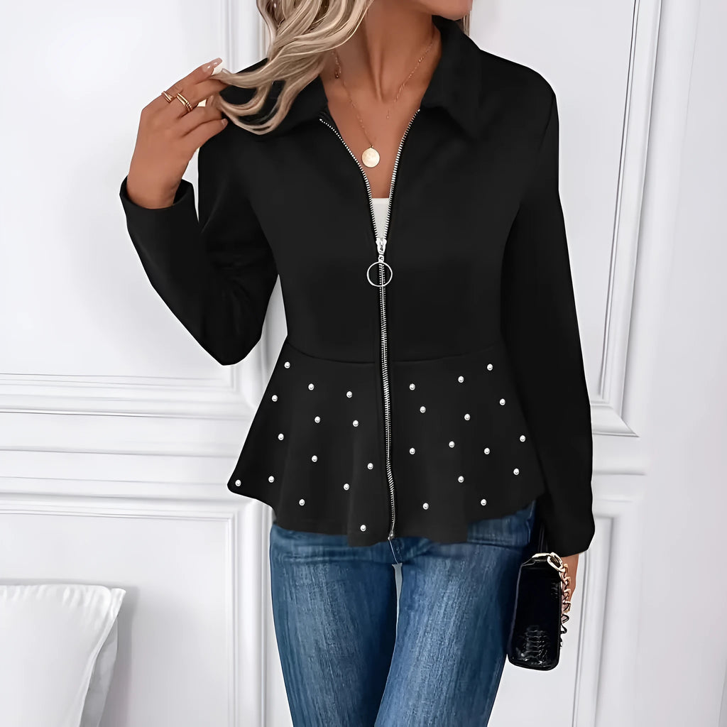 Women's black loose-fit coat with heavy-duty zipper front and ruffled hem detail.