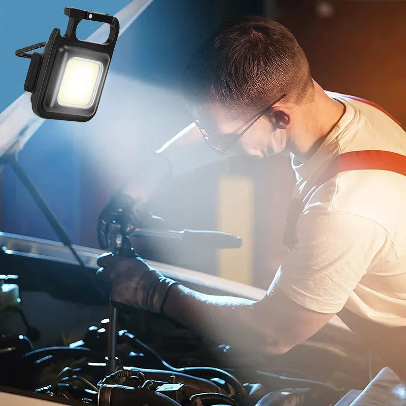 Black aluminum alloy USB rechargeable keychain light with magnetic base and foldable handle