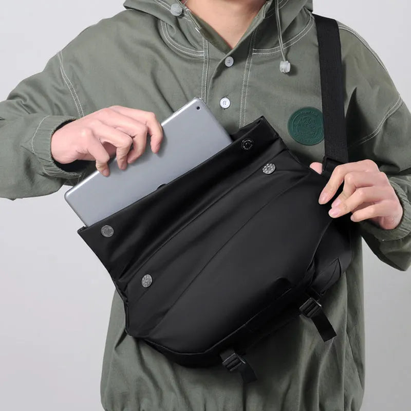 Grey medium crossbody bag with zipper opening showing internal phone and document compartments