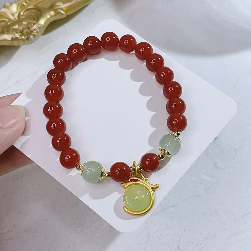 Handcrafted red agate bracelet for women with dragon charm, Chinese style design.
