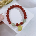 Handcrafted red agate bracelet for women with dragon charm, Chinese style design.