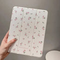 Transparent floral tri-fold iPad protective case showing magnetic stand functionality for Apple tablet models