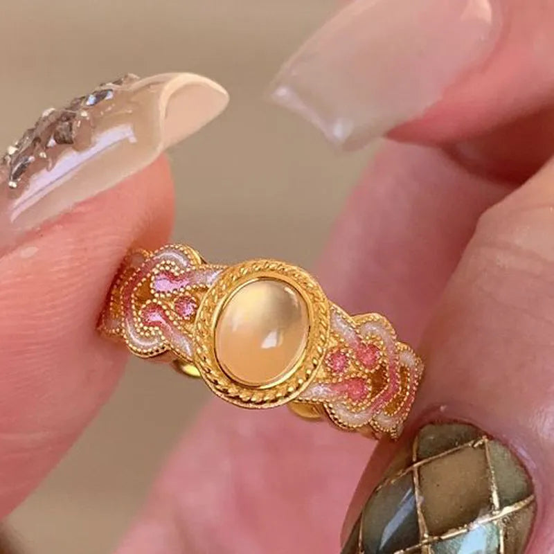 Geometric open mouth women's ring with pink crystal enamel on gold-plated copper.