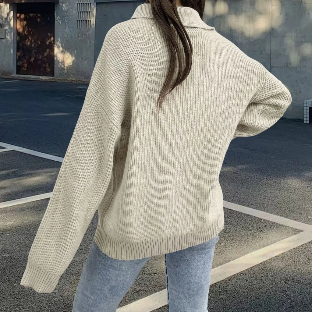 Light khaki women's alpaca wool sweater with oblique zip, turtleneck, and loose lapels.