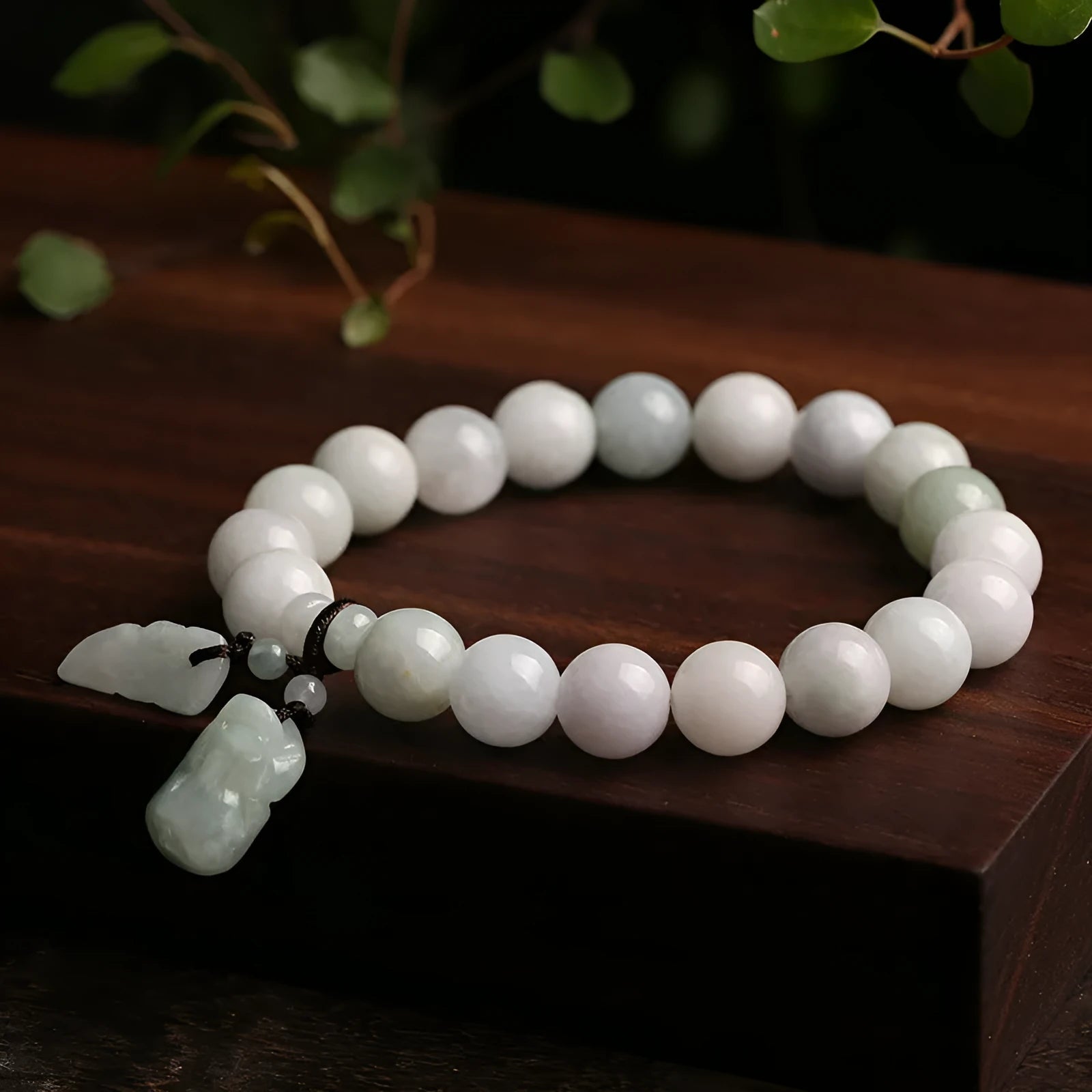 Jade hanging charm bracelet with geometric design and Buddhist symbolic pendant