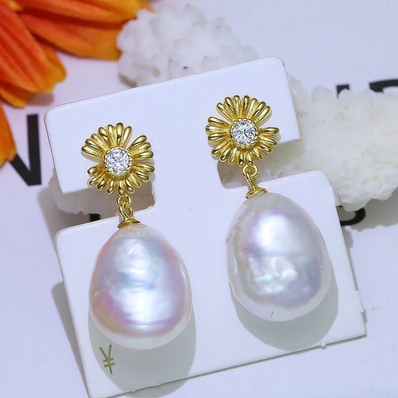 S925 sterling silver baroque flower design earrings and ring holder on a table.