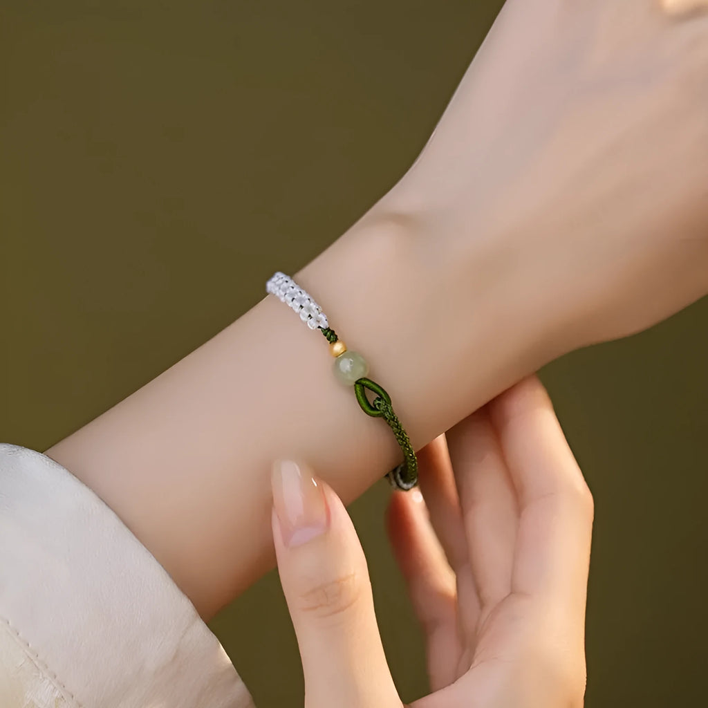 Women's Chinese national bracelet with Hetian jade charm on cord carrying strap