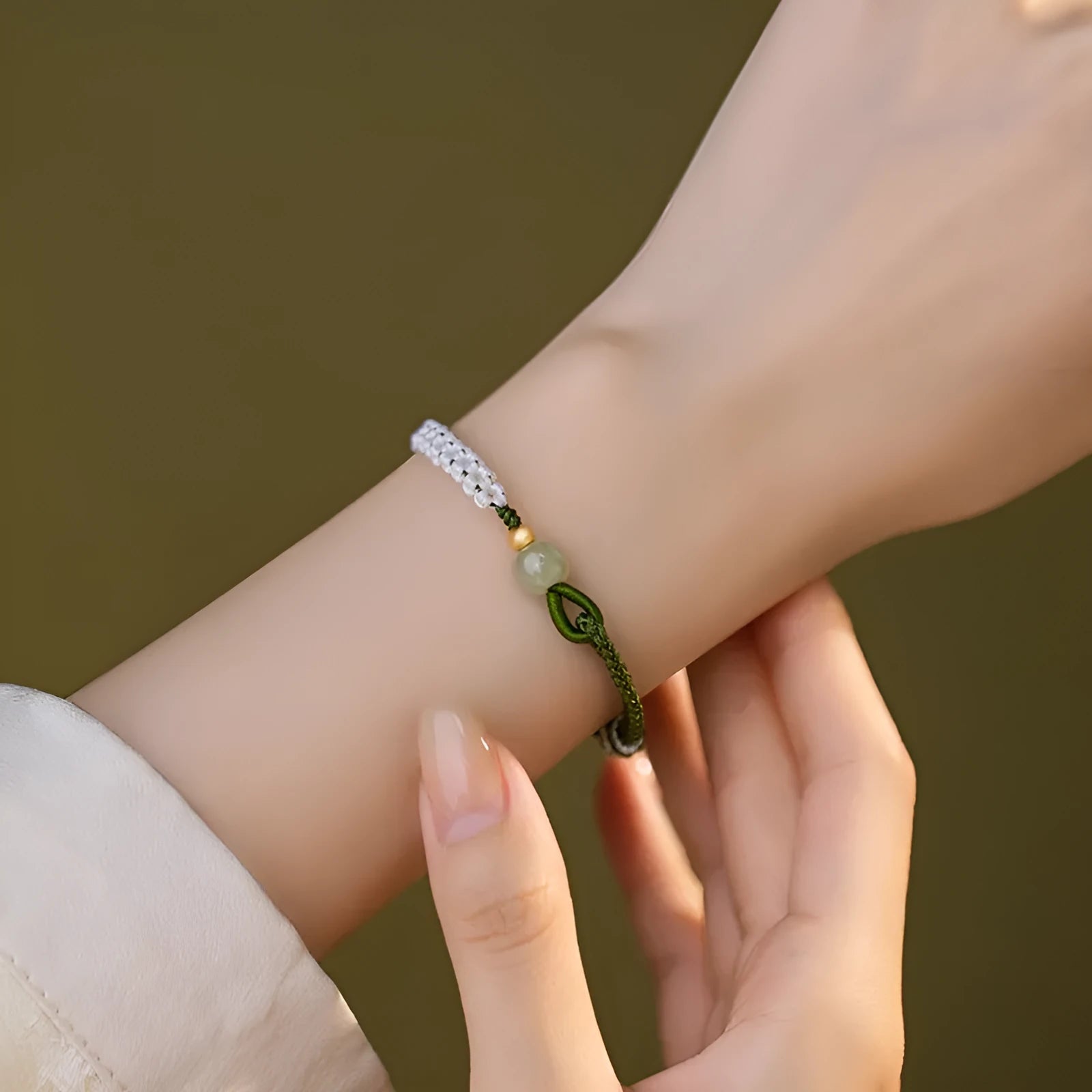 Women's Chinese national bracelet with Hetian jade charm on cord carrying strap