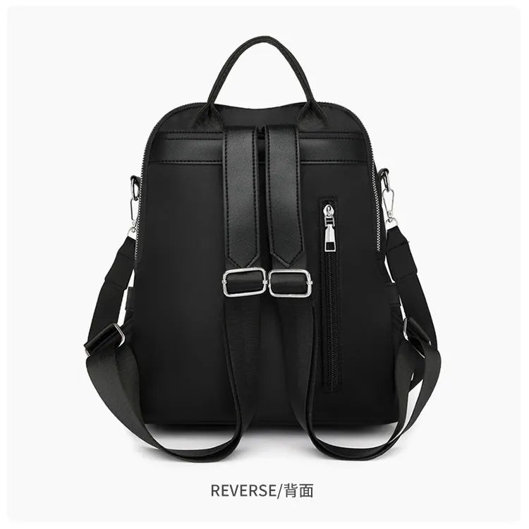 Large black PU backpack with a three-dimensional pocket, shown open to reveal internal phone pocket.