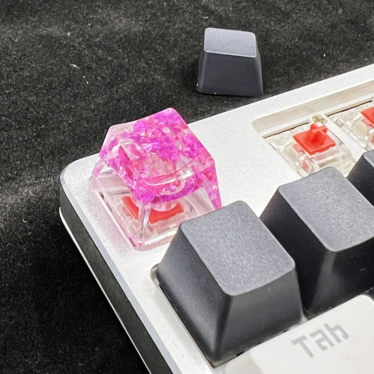 A high-transparency resin mechanical keyboard keycap with a starry sky design, shown in a choice of colours.