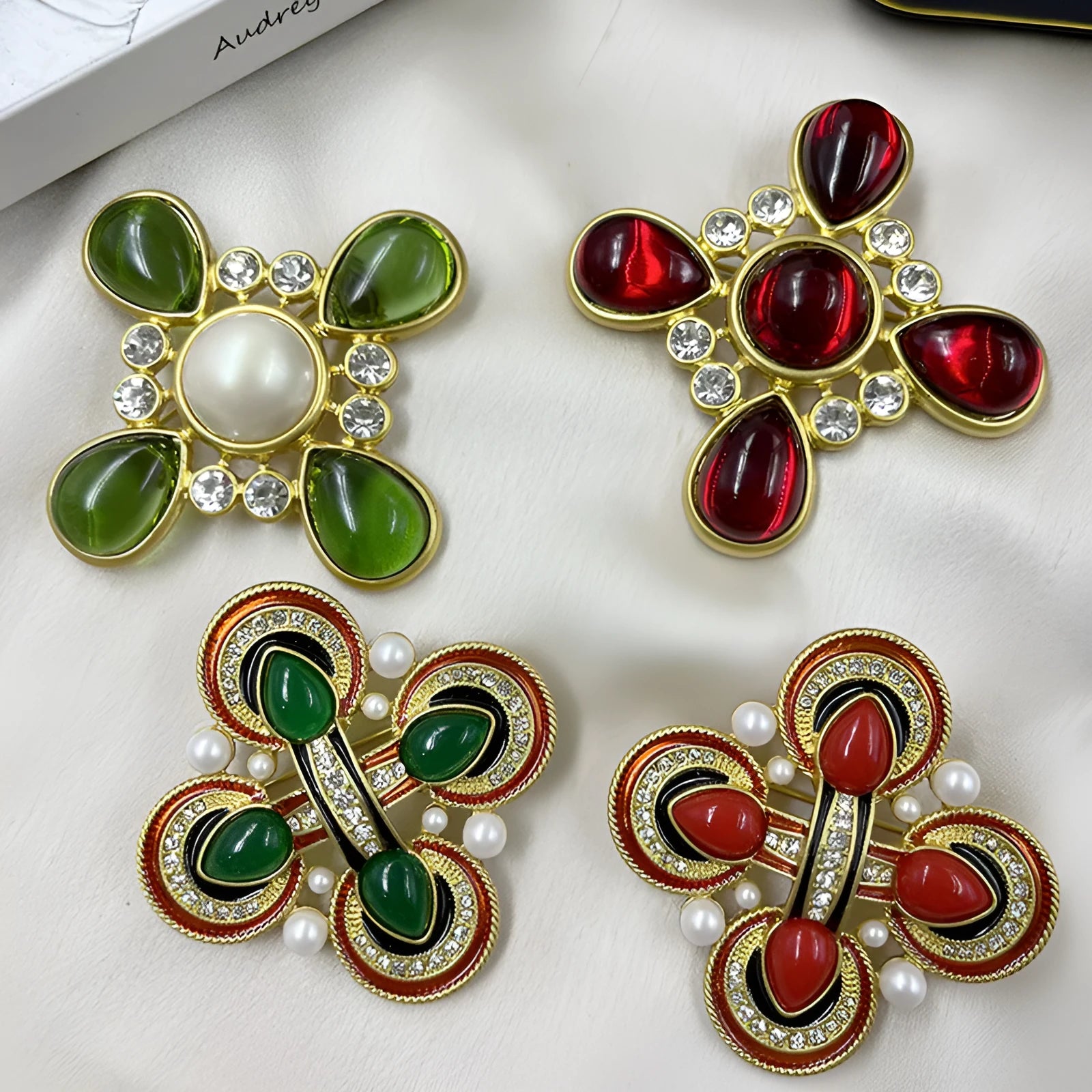 Close-up of a zinc alloy baroque brooch with a central crystal cross in a vintage style.