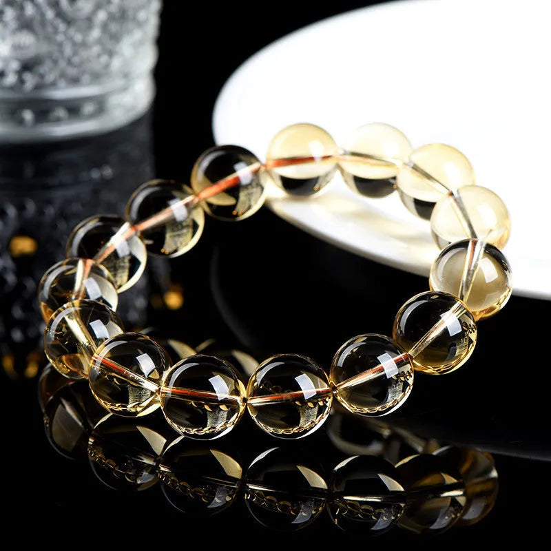 Natural citrine scattered beads bracelet showing polished gemstone beads on a cord.