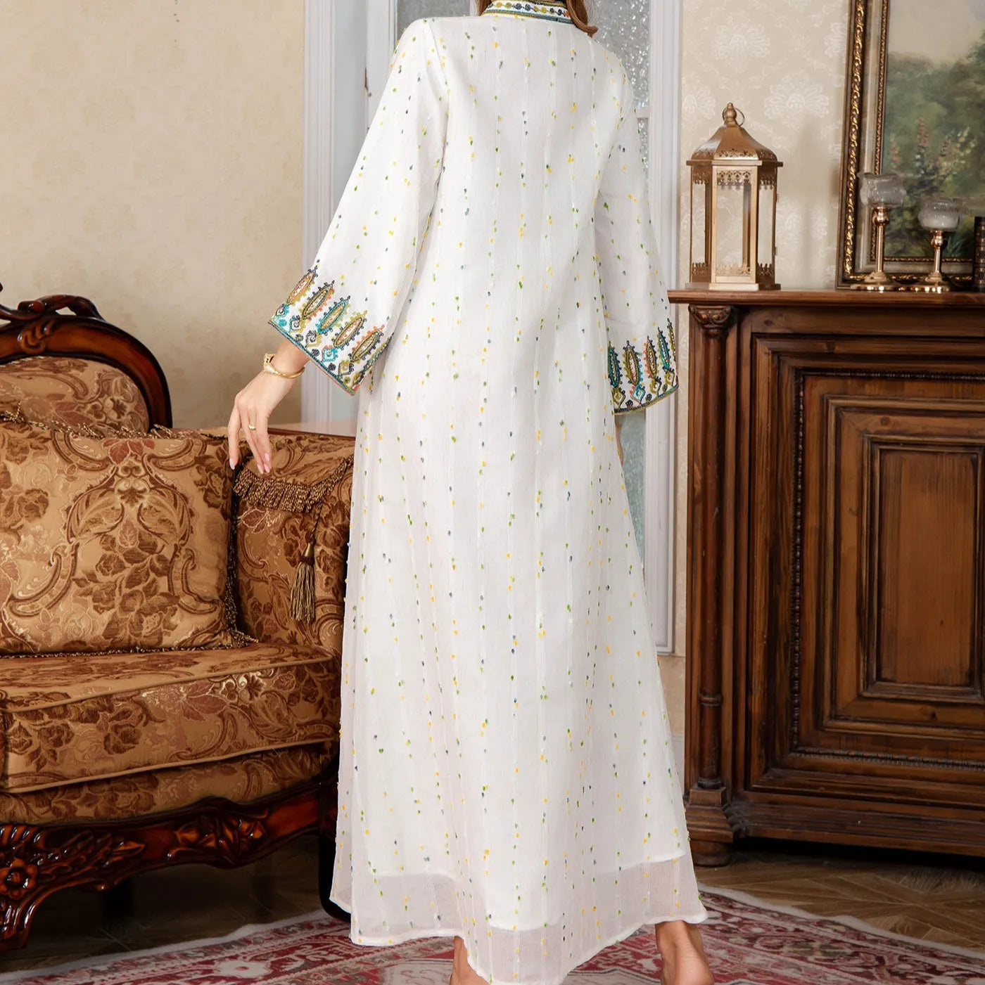 White long Arabic robe dress for women with long sleeves on a hanger