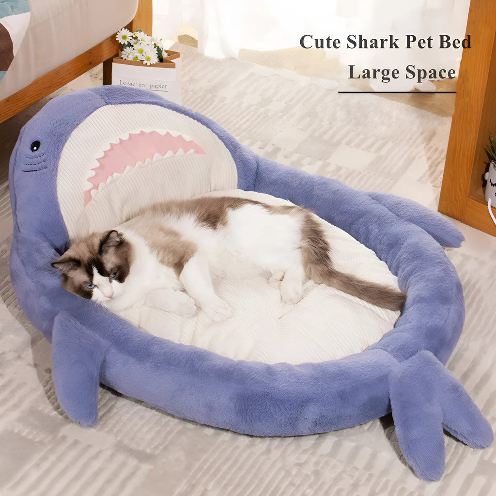 Blue shark pattern velvet pet bed for dogs or cats on a floor.