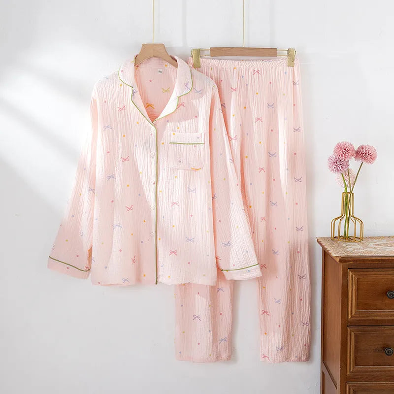 Women's beige cotton crepe pajama set with long sleeves and trousers on a hanger.