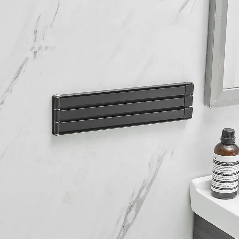 Black folding towel bar with adhesive installation for bathroom use