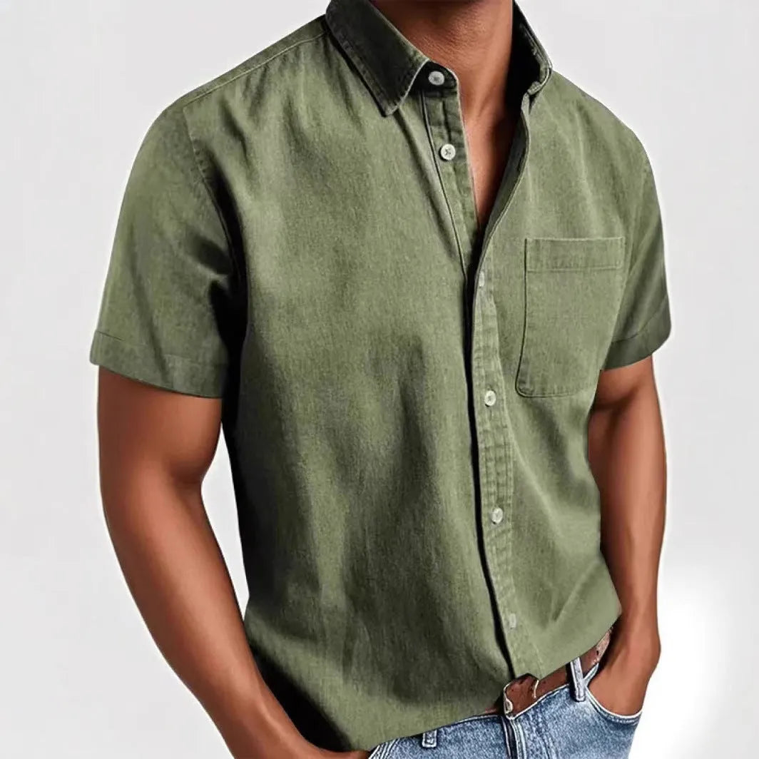 Man wearing a loose grey short sleeve single-breasted cardigan-style shirt.