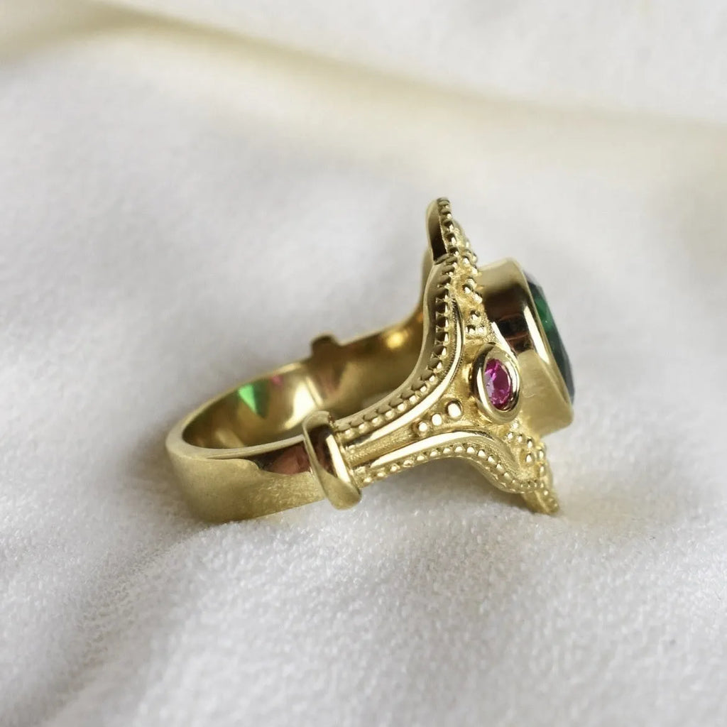 Geometric golden women's fashion ring on a grey background, showing its electroplated alloy construction.