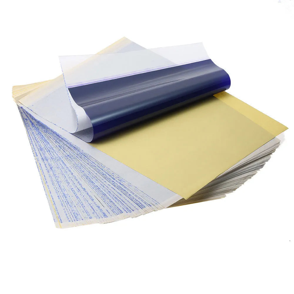 Stack of A4 tattoo transfer paper sheets with clear quadruple lines and transfer gel tube