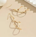 Gold geometric spiral design earrings with oval diamond shape for women