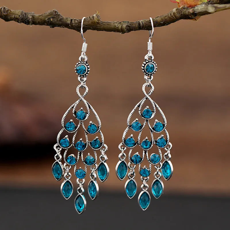 Pair of long purple drop shape fringe earrings with crystals in a retro ethnic style.
