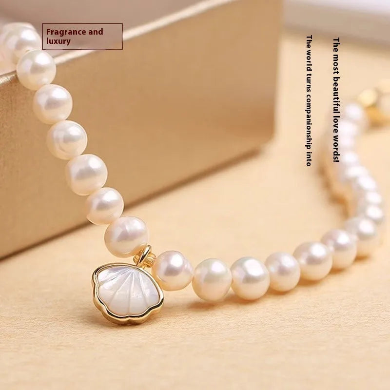 Women's freshwater pearl bracelet with fan-shaped arrangement of 5-6 near round pearls on 16cm band