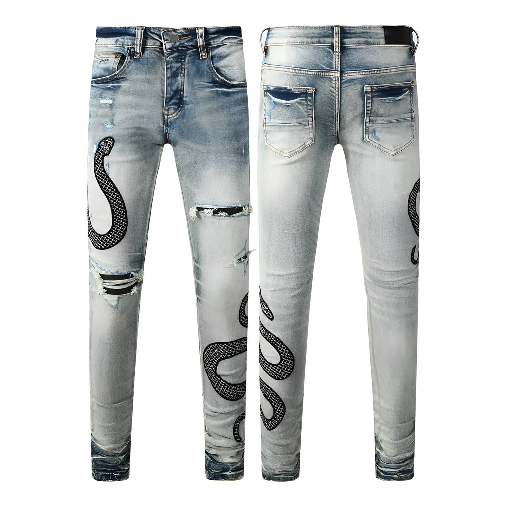 Close-up of vintage blue wash distressed skinny jeans with a tapered leg and button fly.