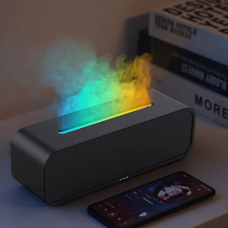 Black Flame Dynamic essential oil aroma diffuser with remote control on a wooden table, showing colour-changing LED lights.