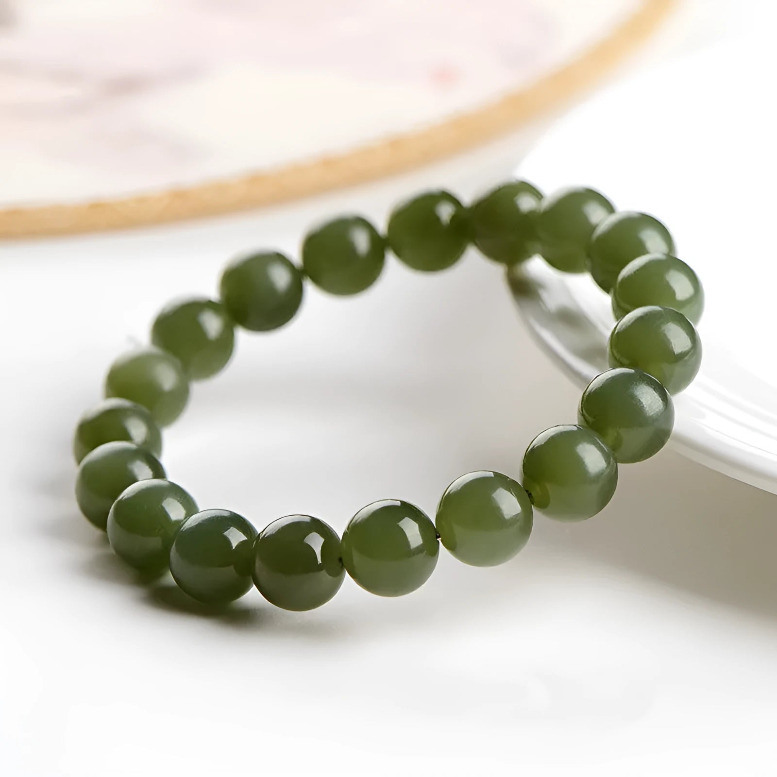 Polished Hetian jade bead bracelet in ice clear colour on a wrist, showing bead detail.