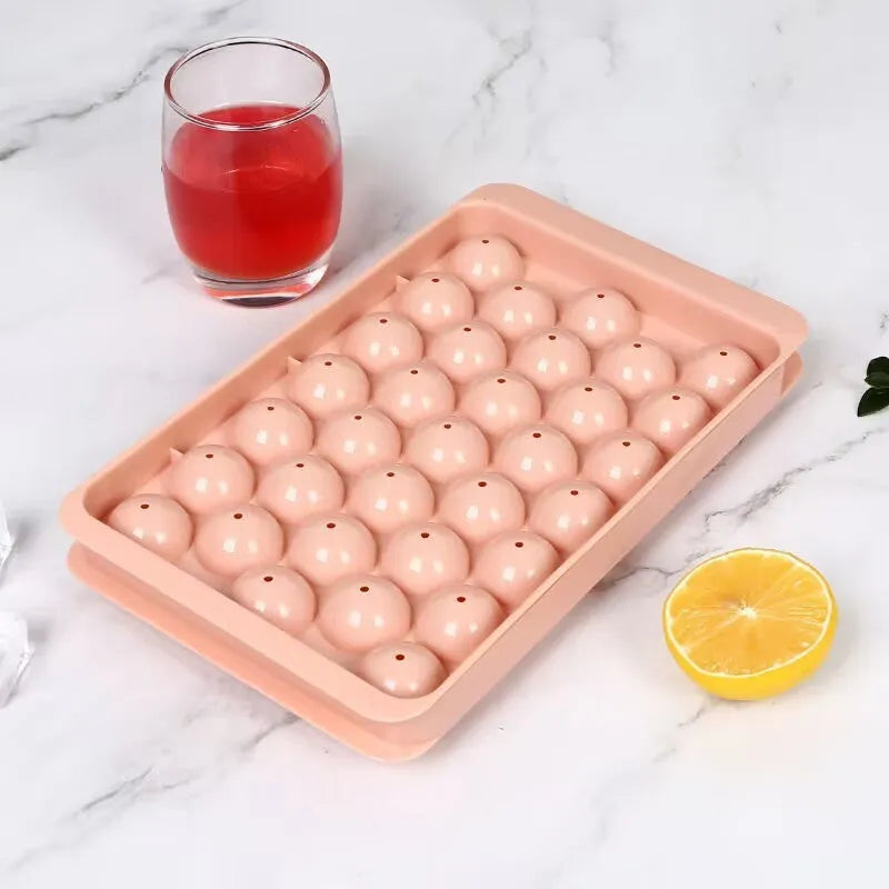 Blue silicone round ice cube tray with lid showing 33 circular moulds