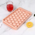 Blue silicone round ice cube tray with lid showing 33 circular moulds