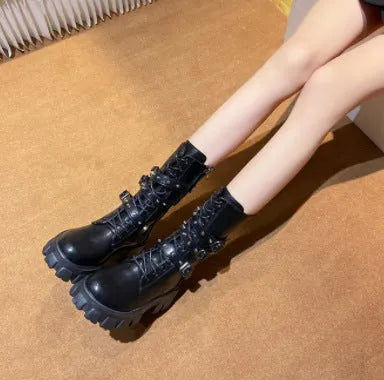 Women's black mid-calf knight boots featuring a metal buckle strap and a side zip closure.