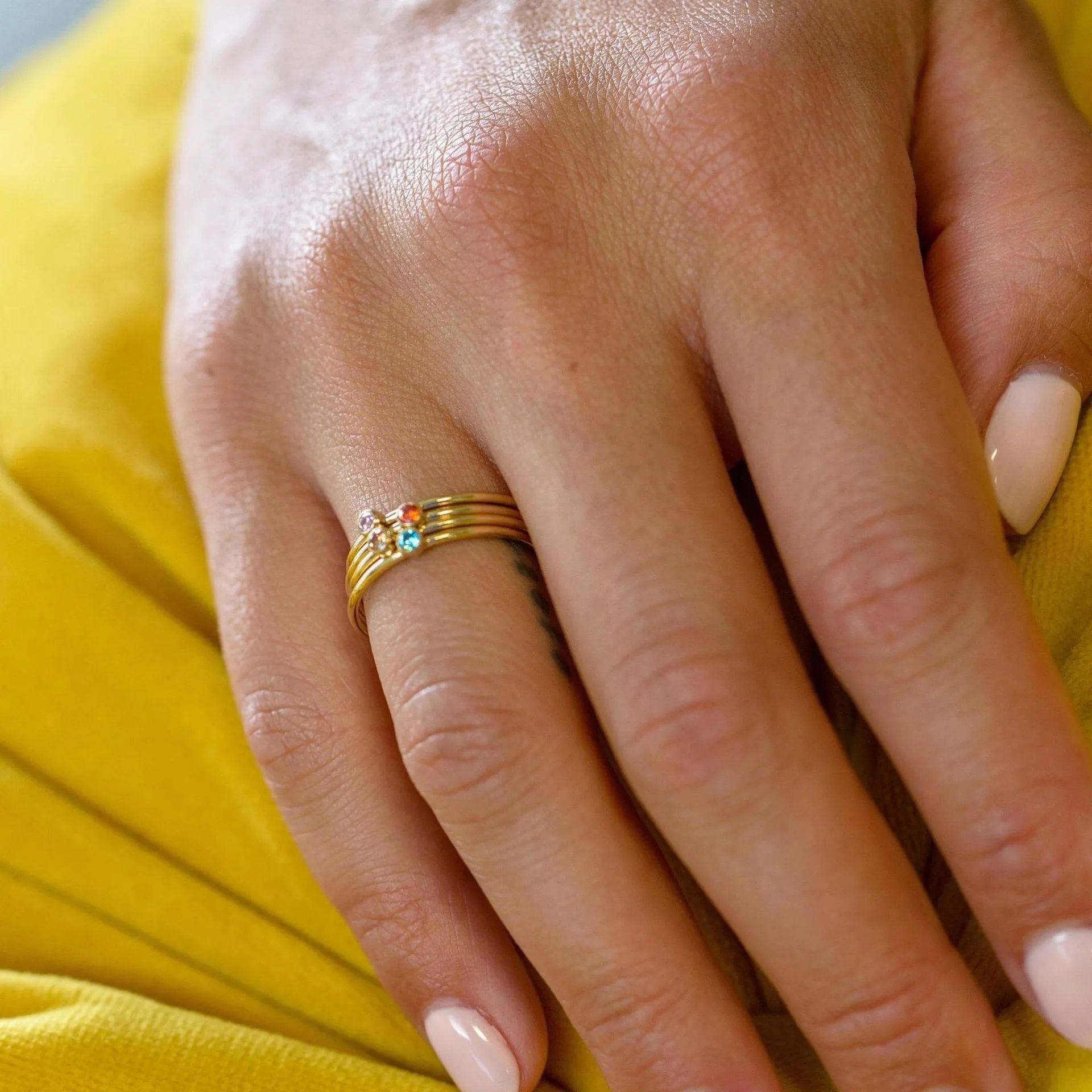 Geometric titanium steel ring with December colour birthstone and superimposed engraving.
