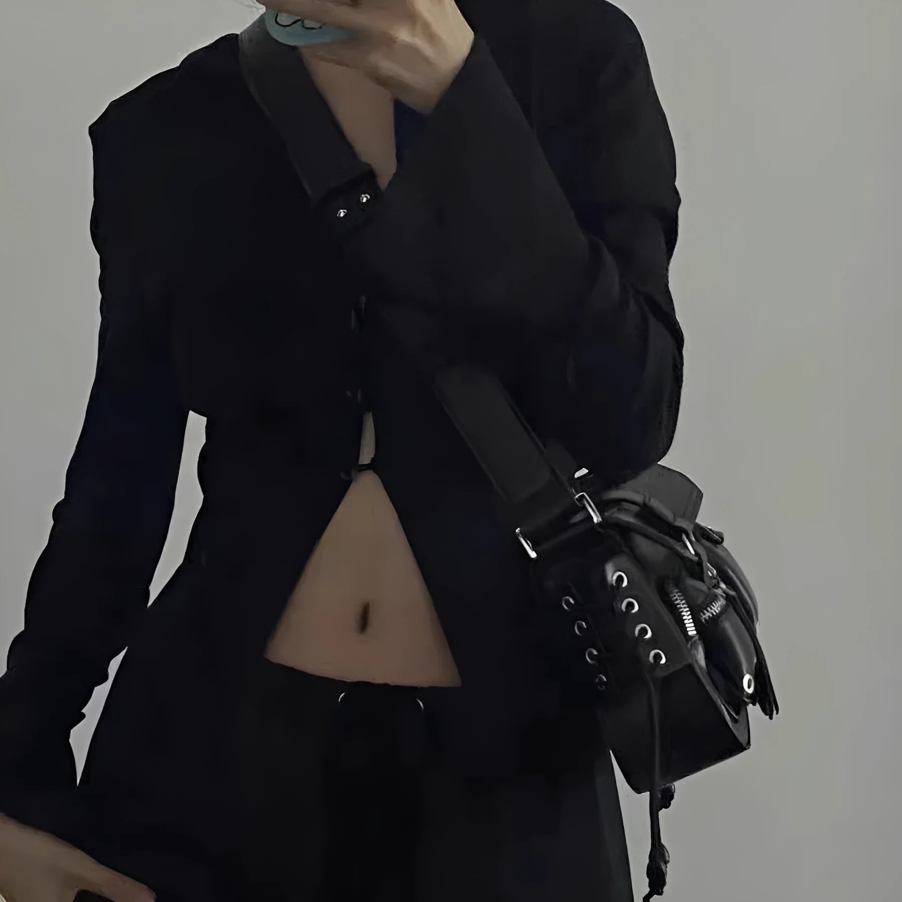 Black PU leather underarm baguette bag with an adjustable long strap.